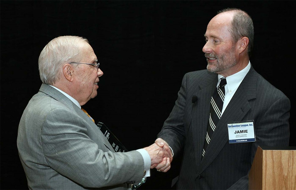 Chairman Jamie C. Kowalski presents Gene D. Burton (left) with Bellwether League Inc.'s Honoree Induction award 