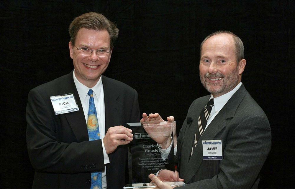 Executive Director Rick Dana Barlow (left), accepts the award for Inductee Charles Housley from Chairman Jamie C. Kowalski (right)