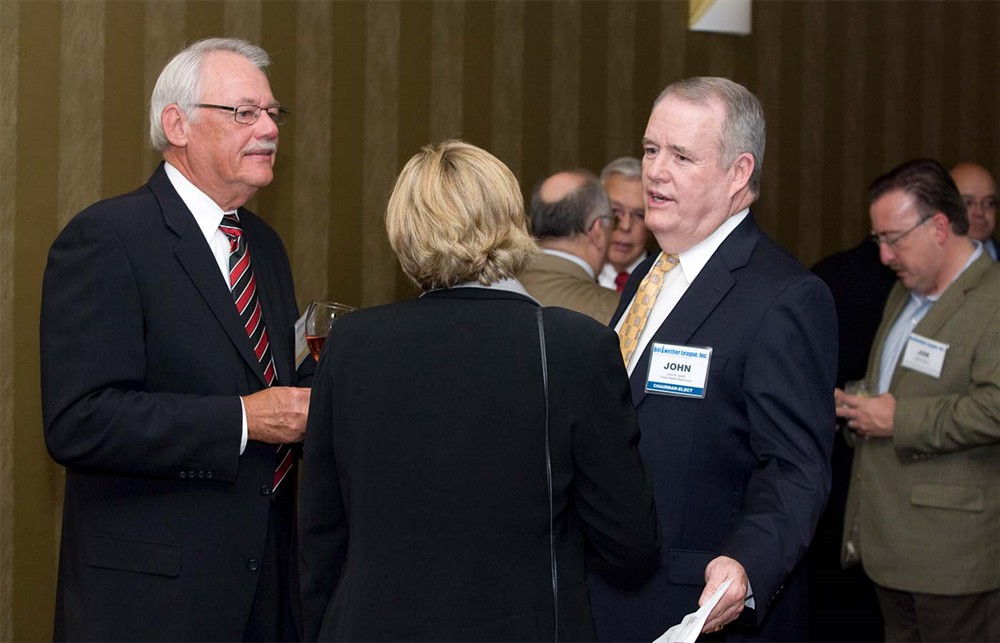 Bellwether Class of 2008’s Lee Boergadine (left) listens as Bellwether League Inc. Chairman-elect John Gaida (right) emphasizes a point with Bellwether League Inc. Treasurer Mary Starr (back to camera).