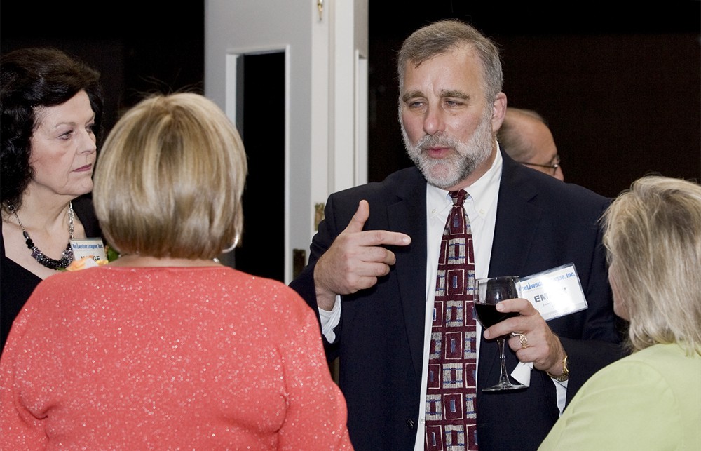UHC’s Emmet Goldberg speaks with Roberta Graham, R.N., (left, back to camera) (Bellwether Class of 2012)