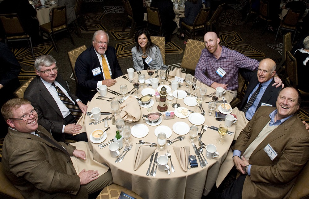 Table 10 featured John Clarke (Bellwether Class of 2012), along with his son Brian Clarke, and executives from Founding Sponsor Premier, Defense Health Support Systems, and Bellwether League Board Member John Strong