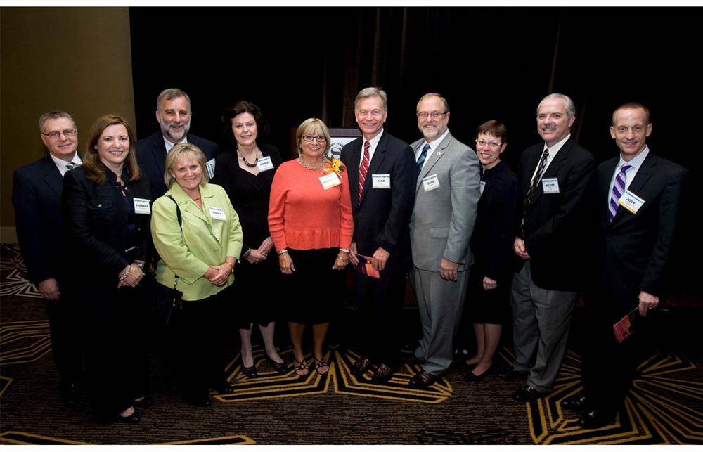 Roberta Graham, R.N. (Bellwether Class of 2012) (center in red) is flanked by her colleagues and supporters from UHC, VHA and Novation.