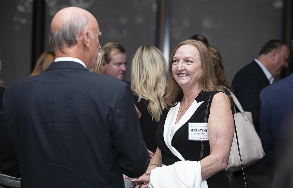 Silver Sustaining Sponsor Healthcare Purchasing News’ Kristine Russell (Bellwether Class of 2017) chats with Dick Perrin (back to camera) (Bellwether Class of 2014).
