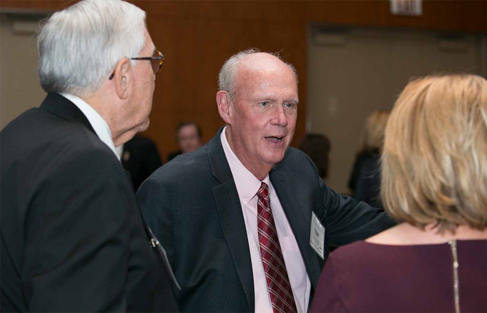 SMI’s Tom Hughes (Bellwether Class of 2012) with Fred Brown (left) and Wendy Francis, wife of Bellwether Class of 2017 Honoree Jim Francis (back to camera).