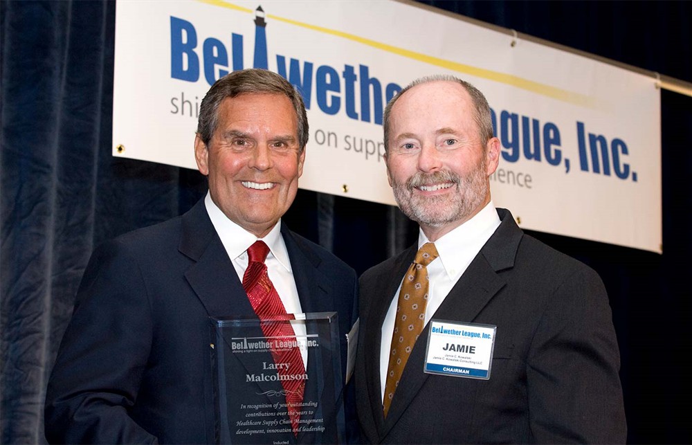 Bellwether Class of 2011 Inductee Larry Malcolmson accepts his Beacon award from Jamie C. Kowalski.