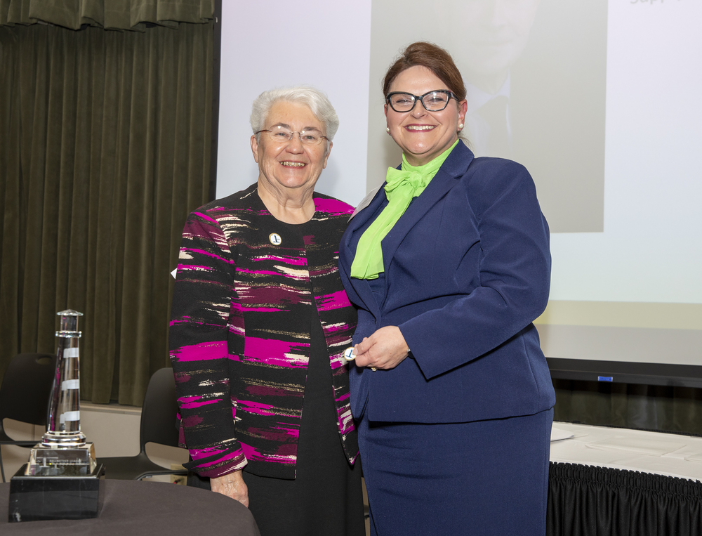 Strain with RDA Healthcare_s Angie Haggard accepting Ron Denton_s award on his behalf