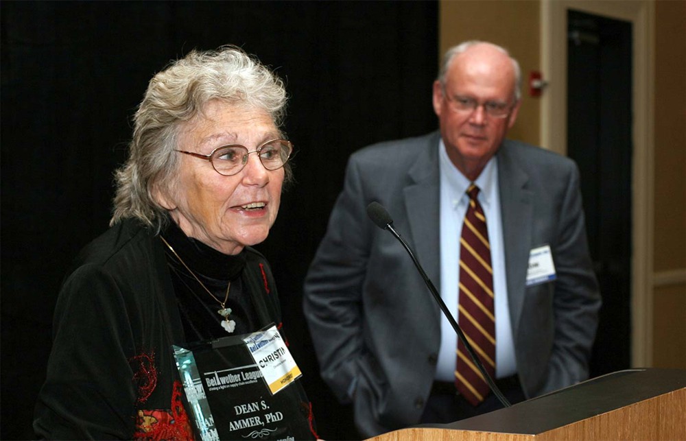 Christine Ammer reflects on the career of Dean S. Ammer, Ph.D., as Bellwether League Inc. Board Member Thomas W. Hughes looks on.