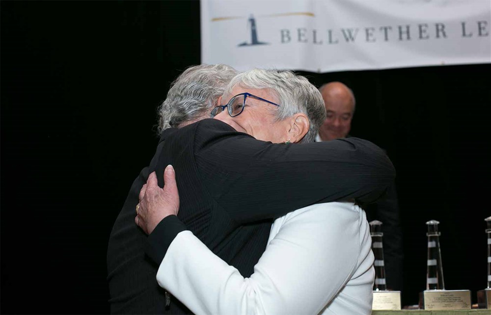 Bellwether League Chairman Nick Gaich embraces Sara Bird.