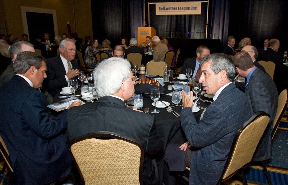 HealthCare Solutions Bureau LLC’s Michael Rudomin (back to camera) converses with Logi-D’s Richard Philippe (right) during the annual dinner.