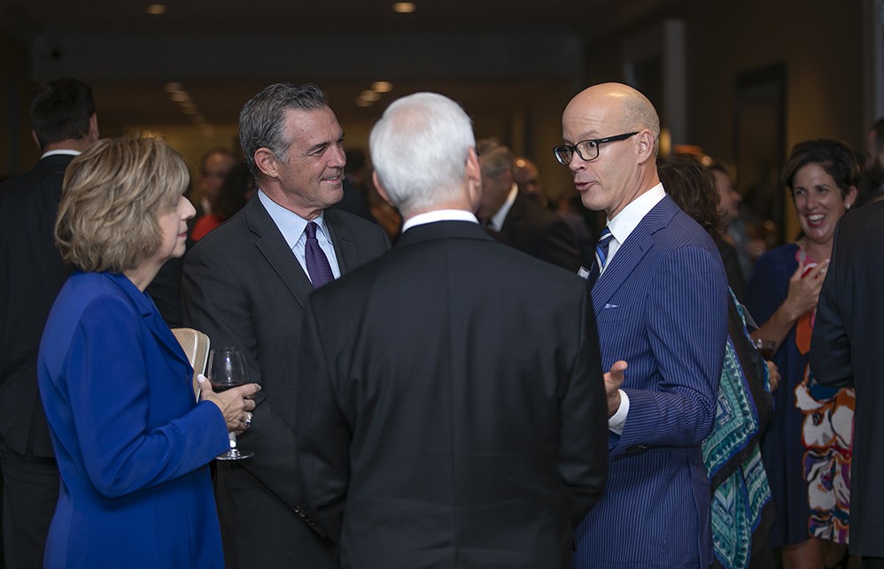 Gartner’s Eric O’Daffer (right) chats with 2019 Honoree Larry Smith (back to camera), 2019 Honoree Kevin O’Marah and Barbara Smith (far left, Larry’s wife).