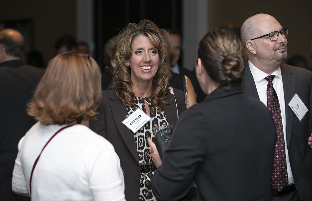 Mercy’s Cherise White, next to Mercy’s Al Webb, enjoys a lighter moment during the VIP Reception.