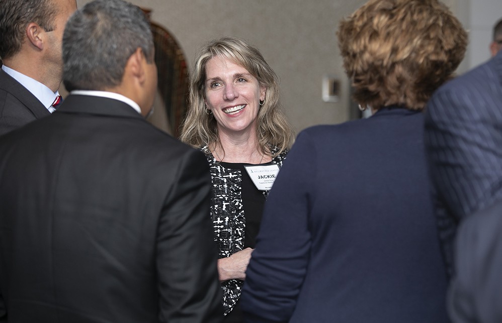 Silver Sustaining Sponsor Capstone Health Alliance’s Jackie Dula (center), chats with Capstone’s Tim Bugg (left, back to camera) and Founding Sustaining Sponsor Premier’s Pam Daigle (right, back to camera).