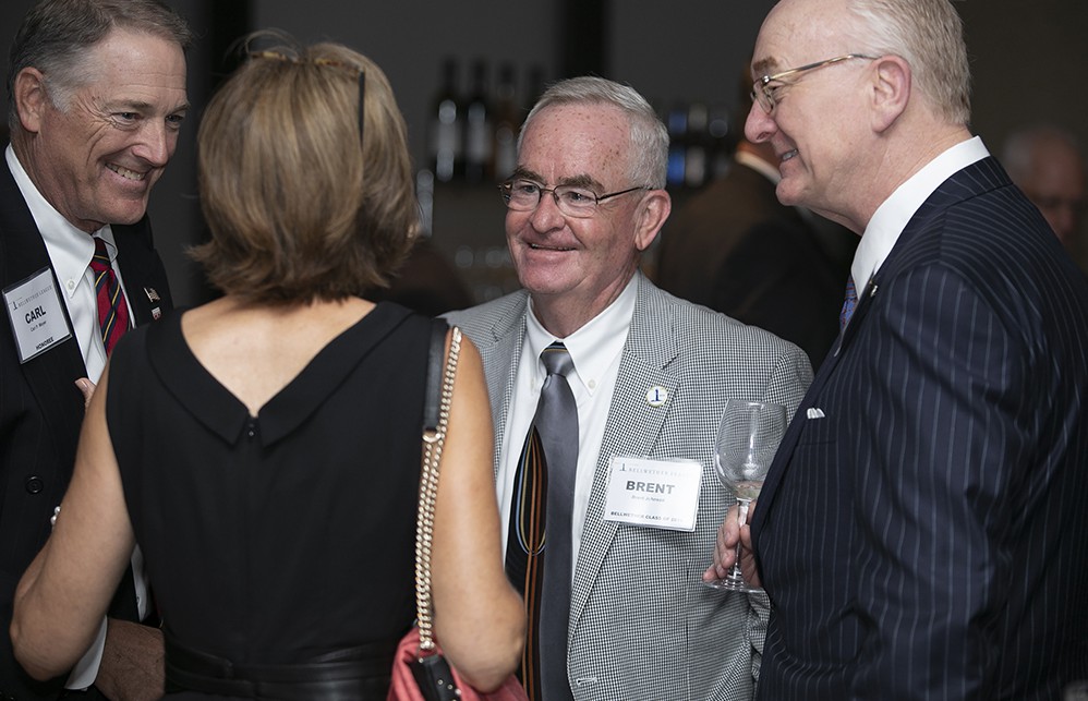 Brent Johnson (Bellwether Class of 2014) speaks with Amy Meyer (back to camera), wife of Carl Meyer (far left) (Bellwether Class of 2019) and Jim Wetrich (far right).